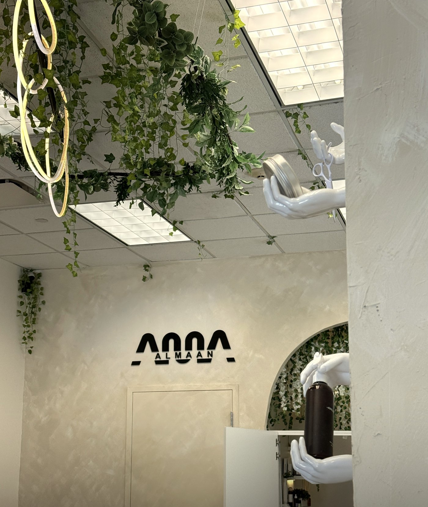 ALMAAN barber chairs and ALMAAN logo wall