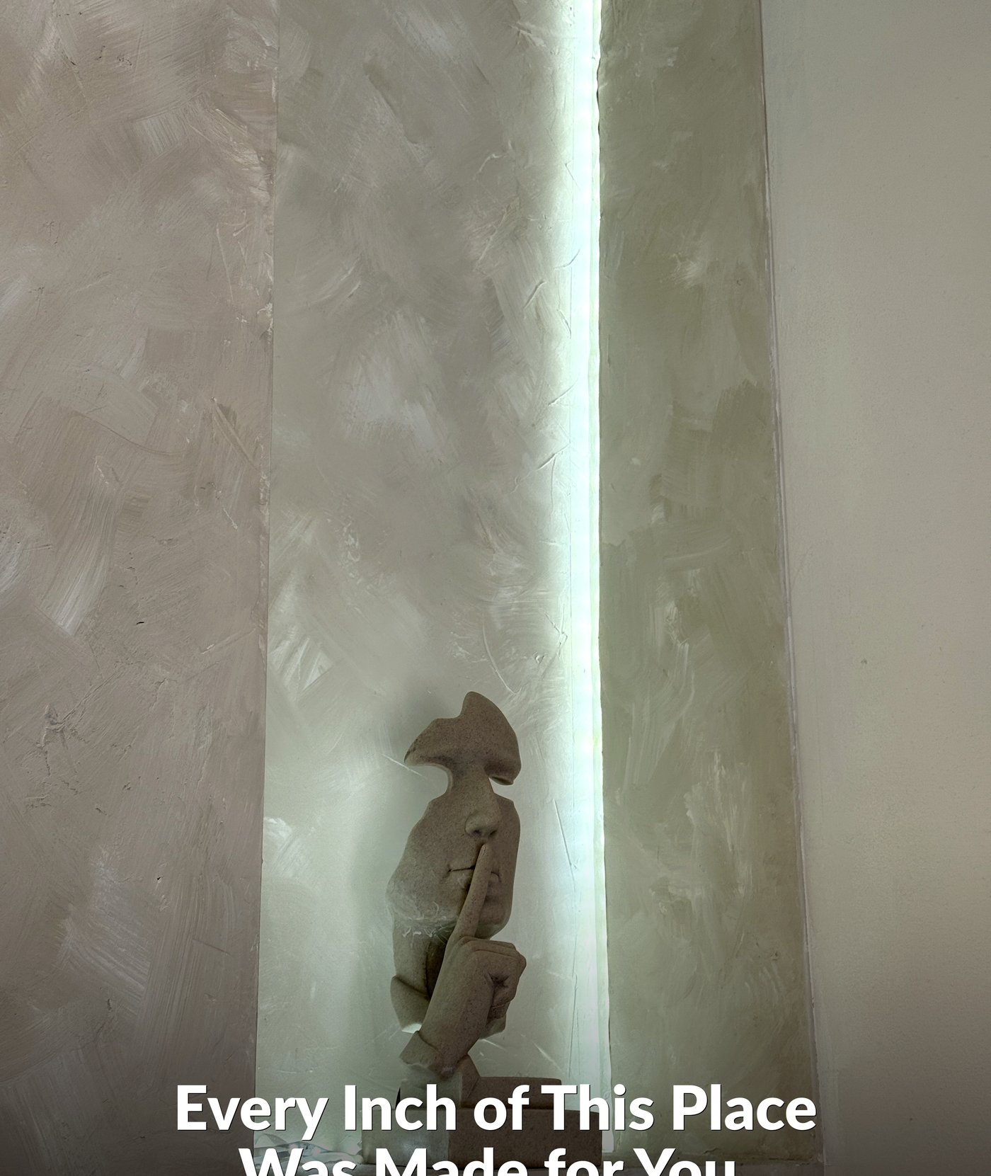 ALMAAN studio — illuminated niche with stone figure sculpture